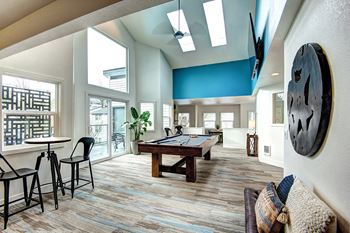 A game room with a pool table and a large window